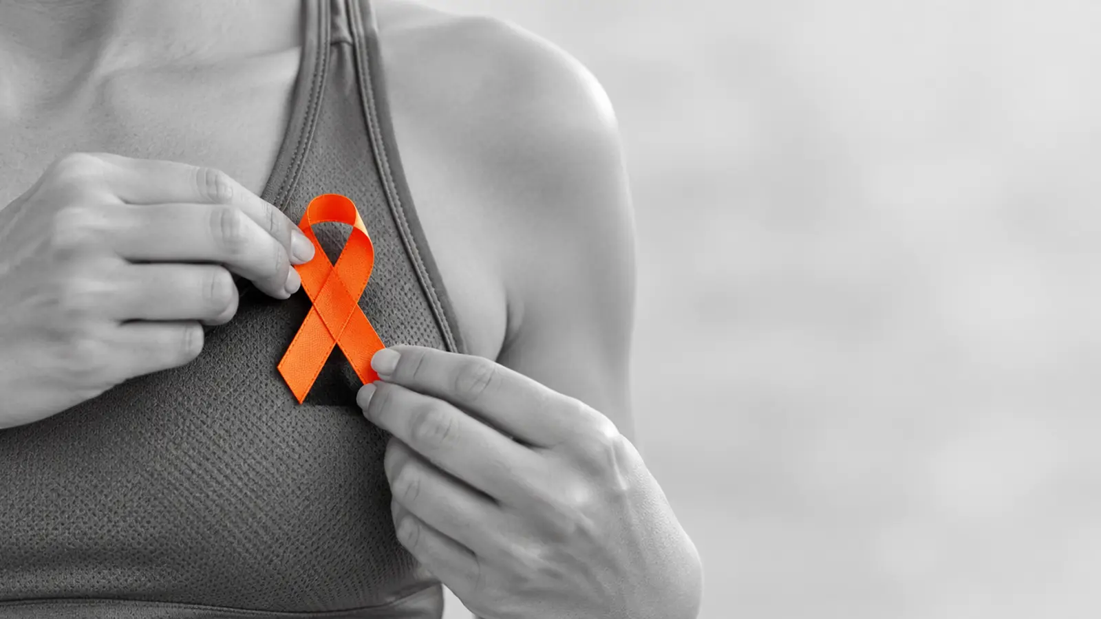 Athlete pinning a charity ribbon to a race top