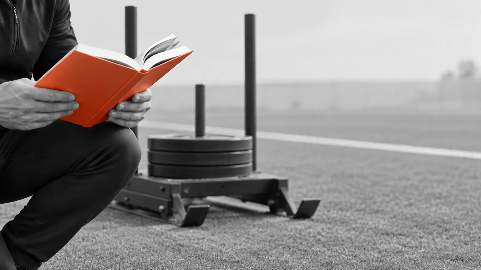 Judge reading a rulebook beside a fitness race station